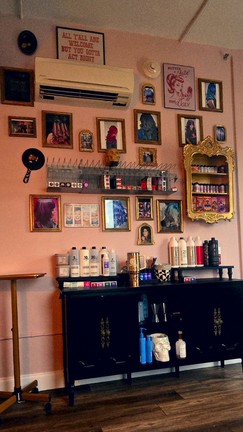 Gallery wall of framed hair transformations in the downtown Seguin studio